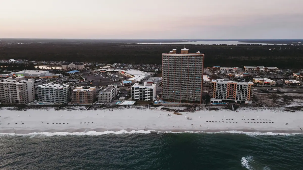 A line of tall buildings along a shoreline seen from across the water